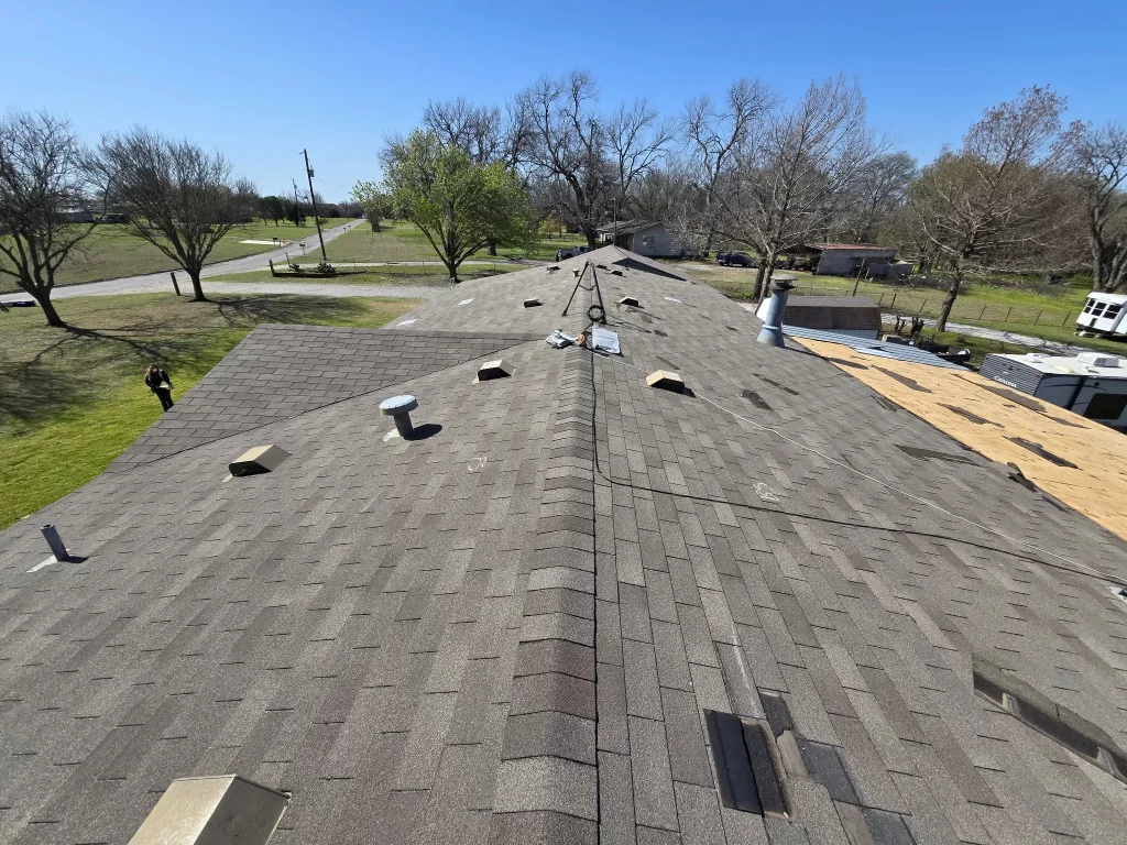 Shingle roof undergoing repair with missing and chalk-marked shingles in McKinney, Texas